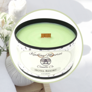 Green candle with wooden wick and flowers.