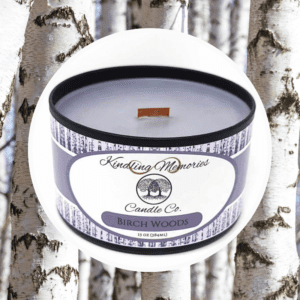 Birch Woods candle against birch tree background.