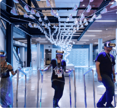 People wearing VR headsets in a modern space.