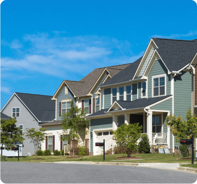 Suburban houses under a clear blue sky.