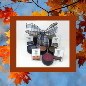 Candles with plaid bow, autumn leaves background.